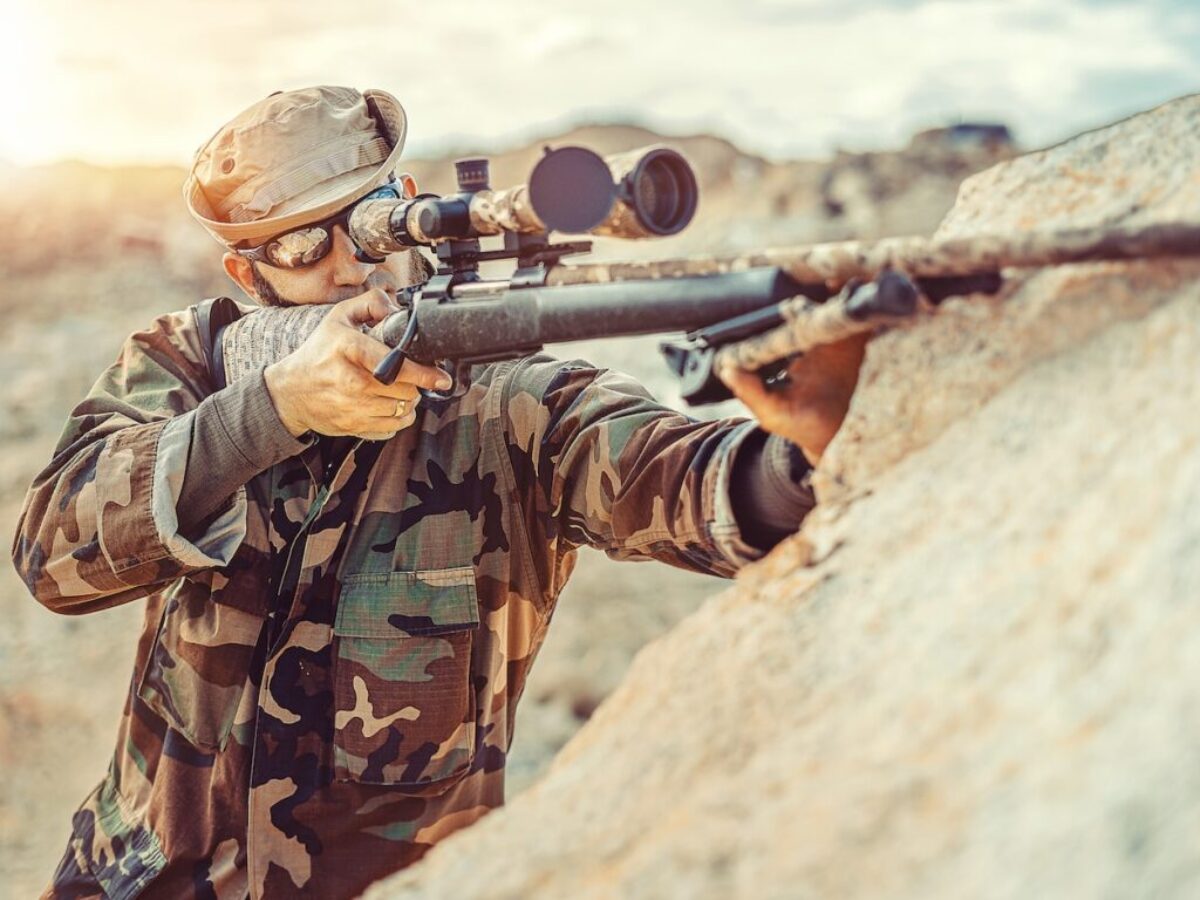 man in green and brown camouflage army suit holding rifle