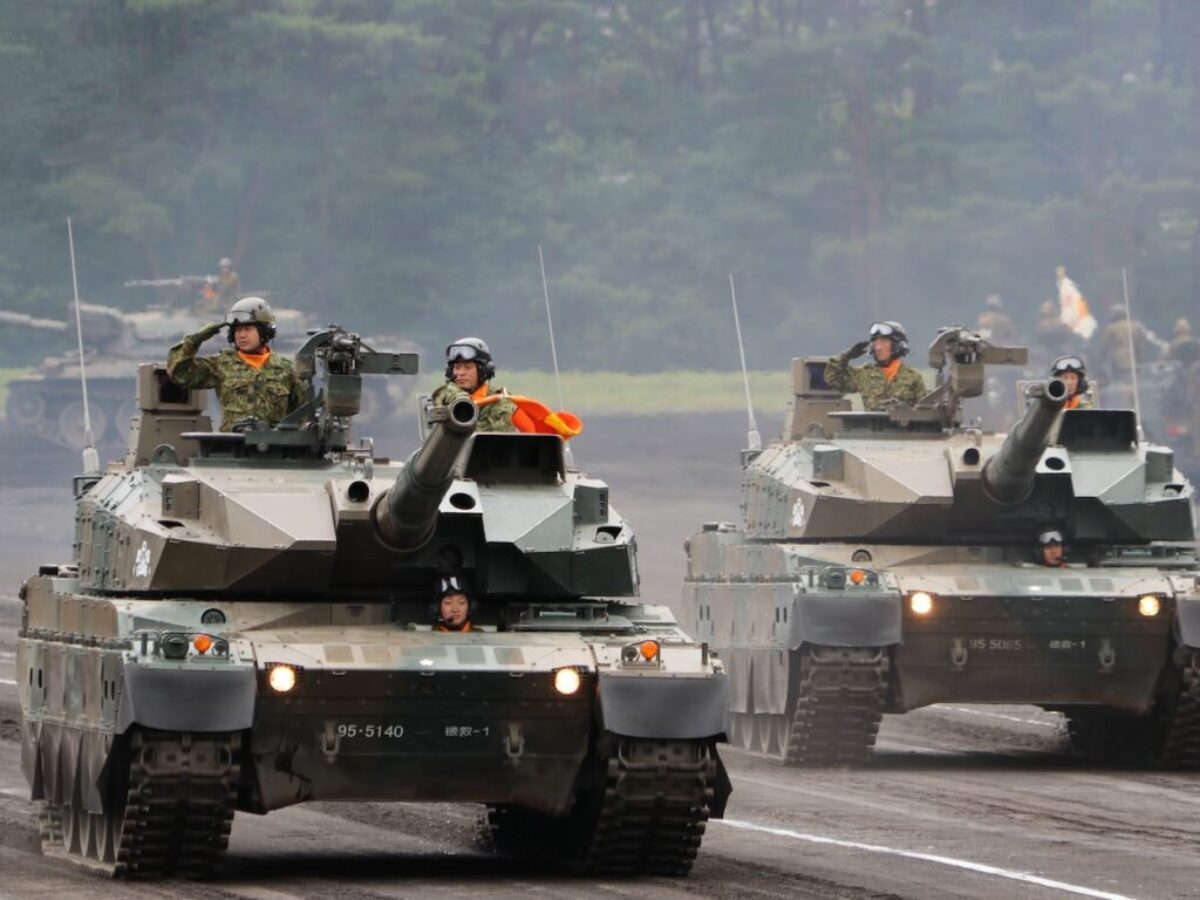 a group of military tanks driving down a road