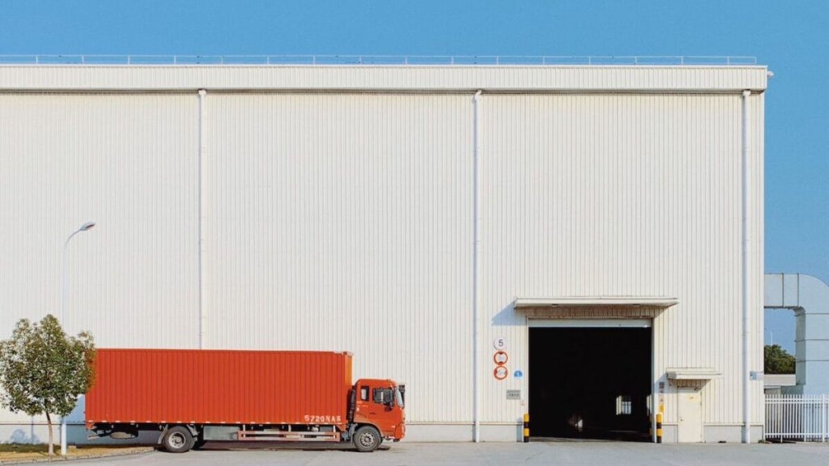 red freight truck beside building