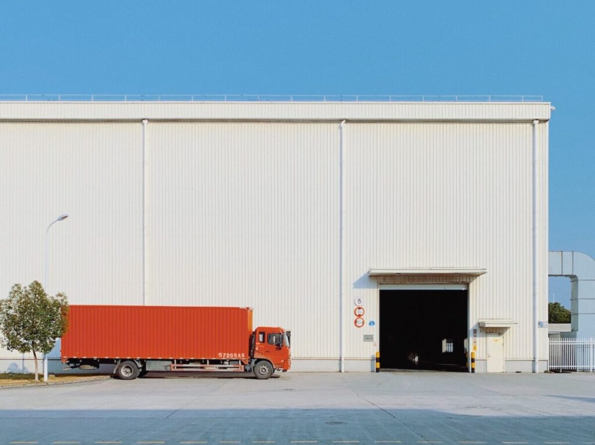 red freight truck beside building