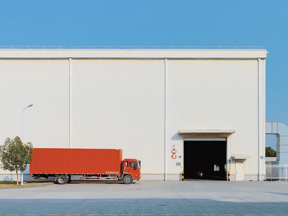 red freight truck beside building