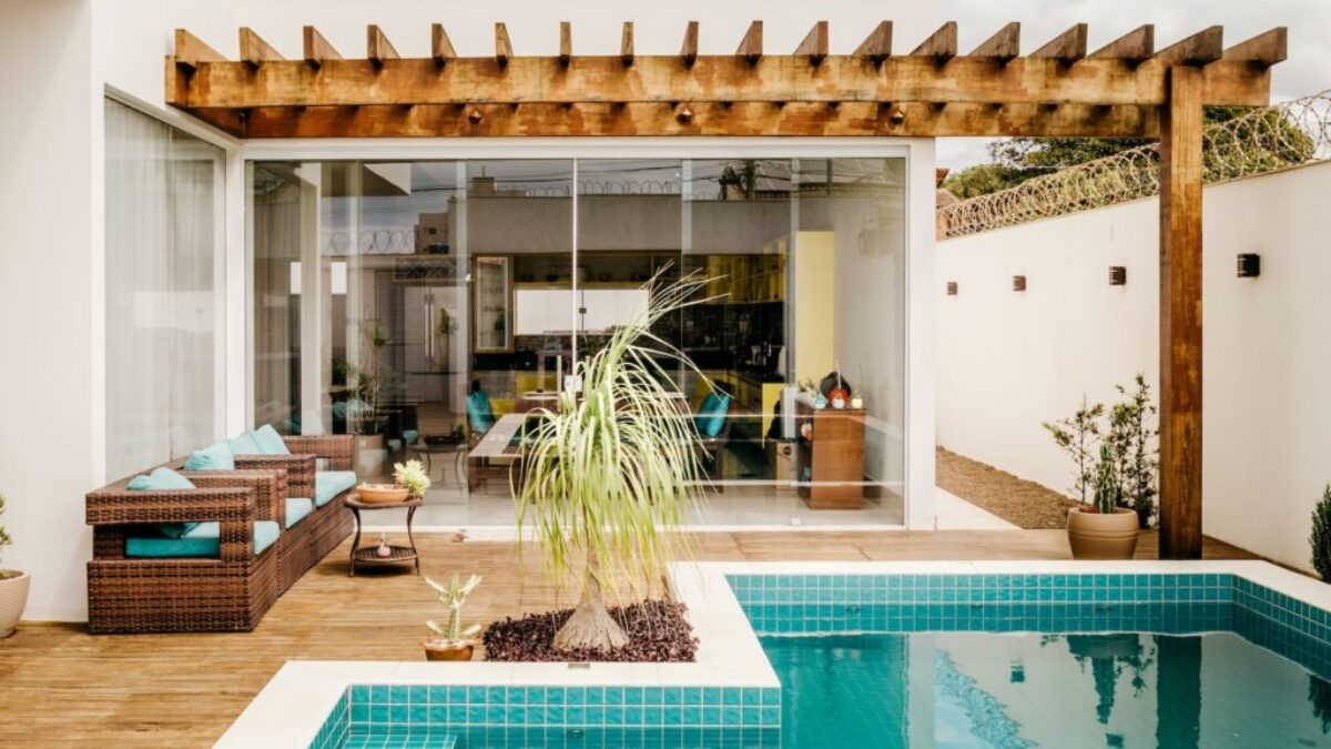 brown wooden table near swimming pool