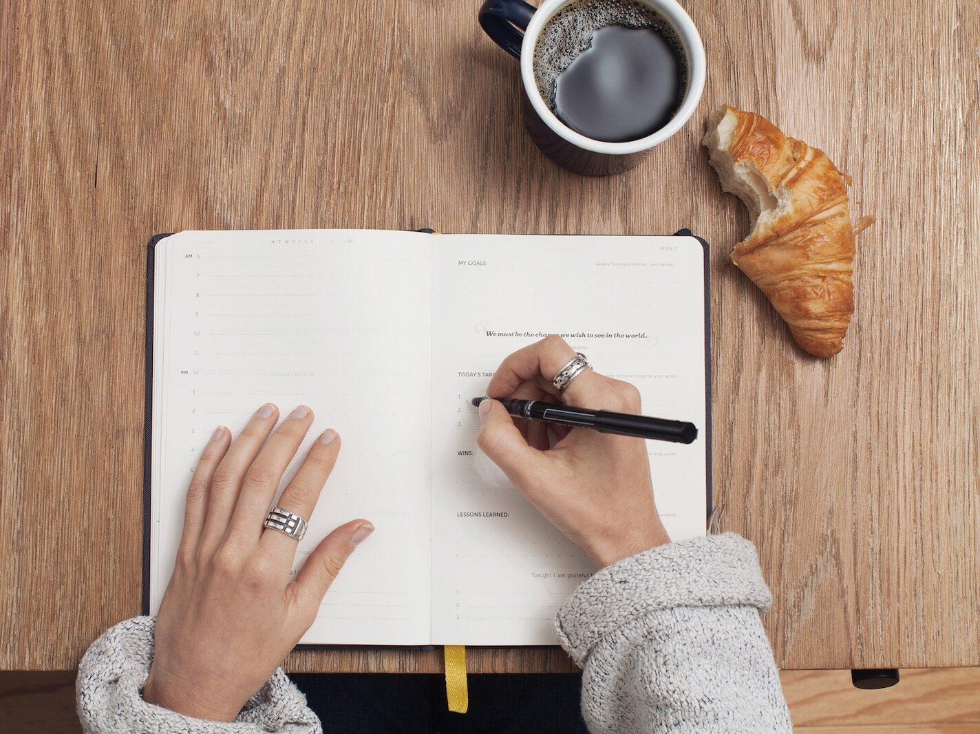 person writing on a book