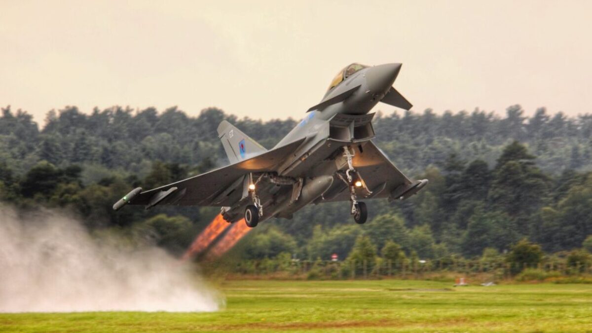 black jet plane on green grass field during daytime