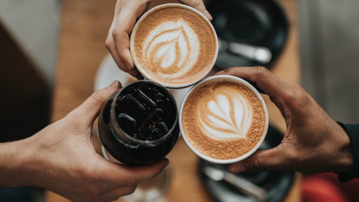 three person holding beverage cups