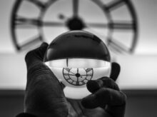 grayscale photography of person holding glass ball