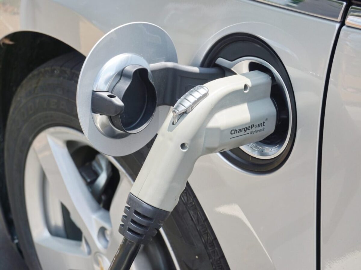 an electric car plugged in to a charge station