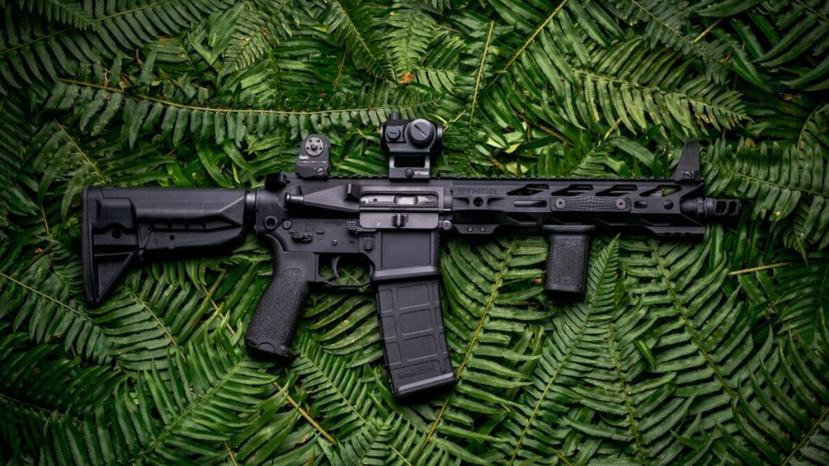 black rifle on green textile