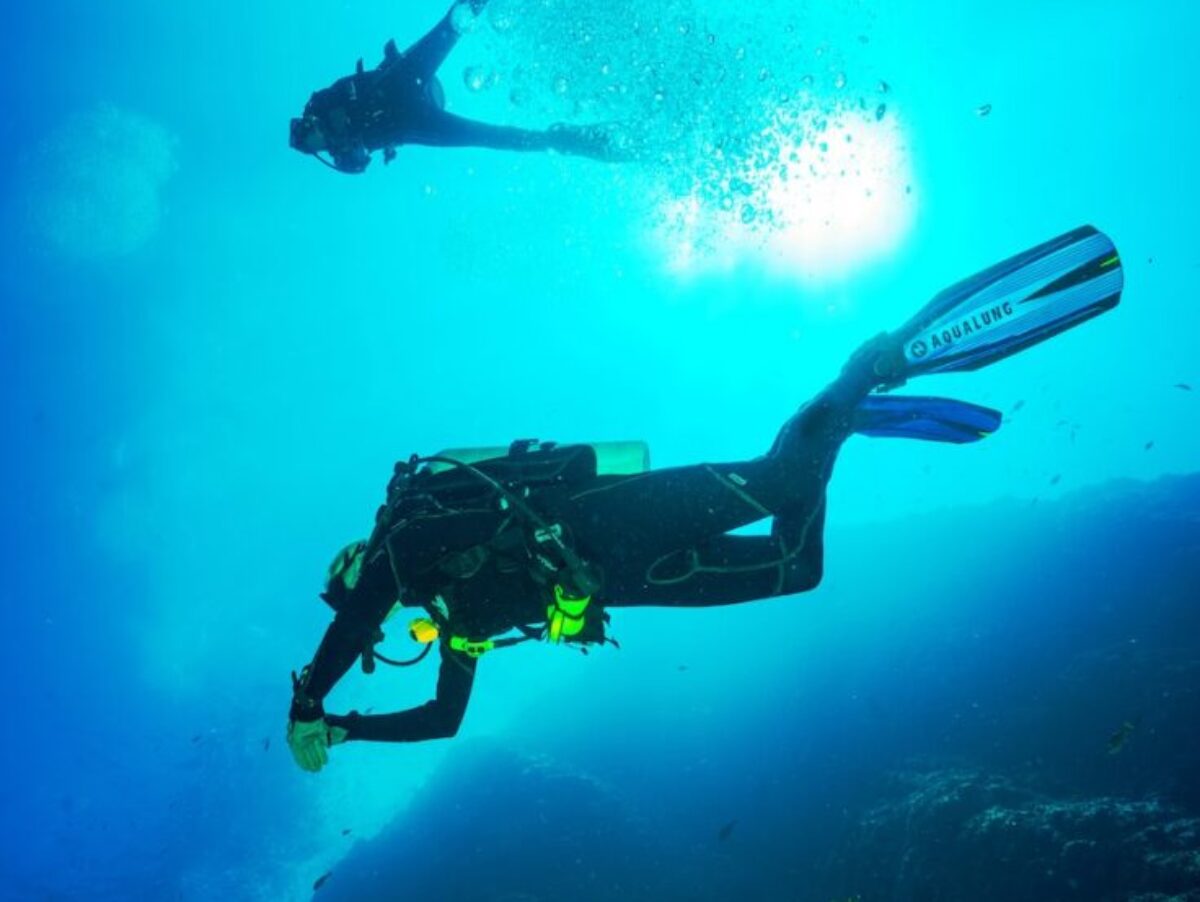 photography of two persons underwater