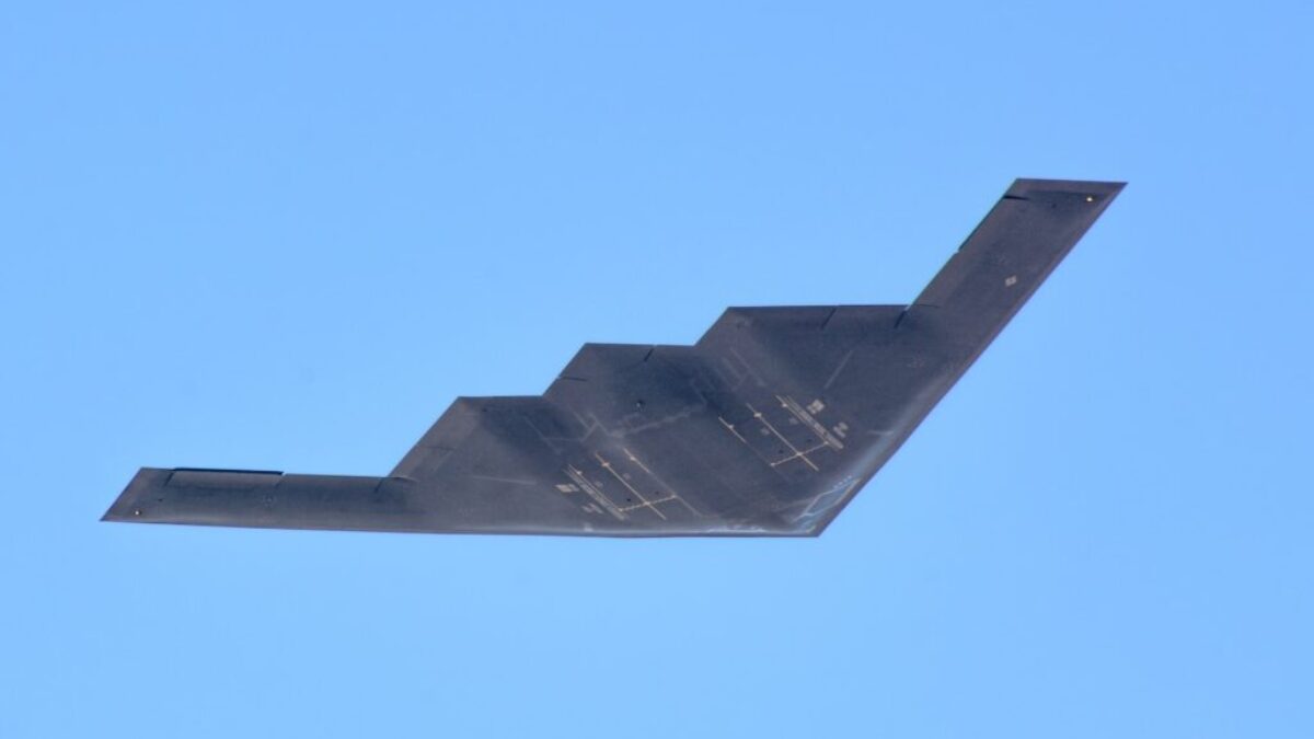 black plane under blue sky during daytime