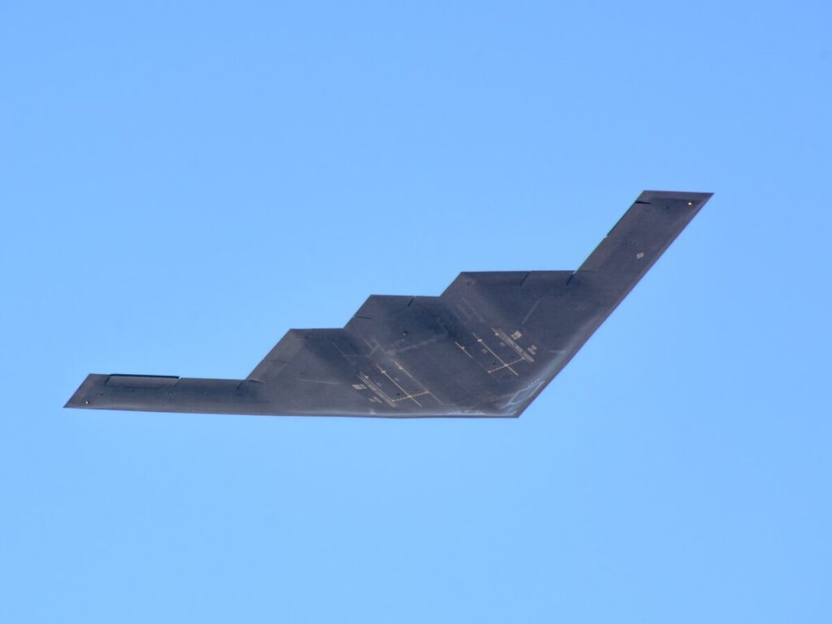 black plane under blue sky during daytime