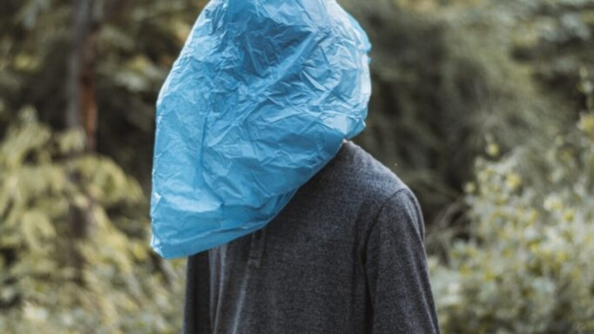 person in blue plastic bag