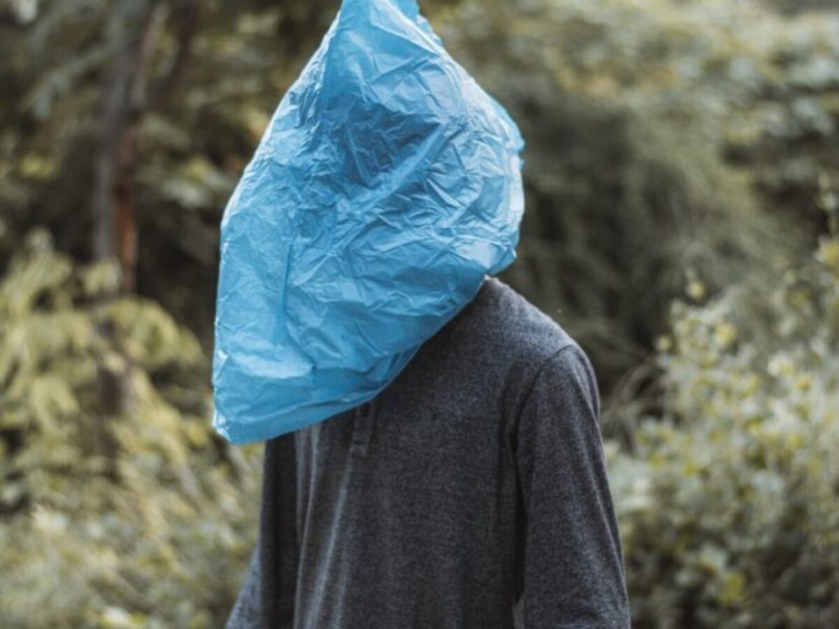 person in blue plastic bag