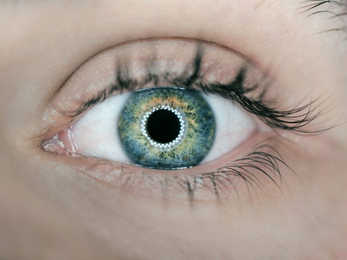 person showing green and black eyelid closeup photography