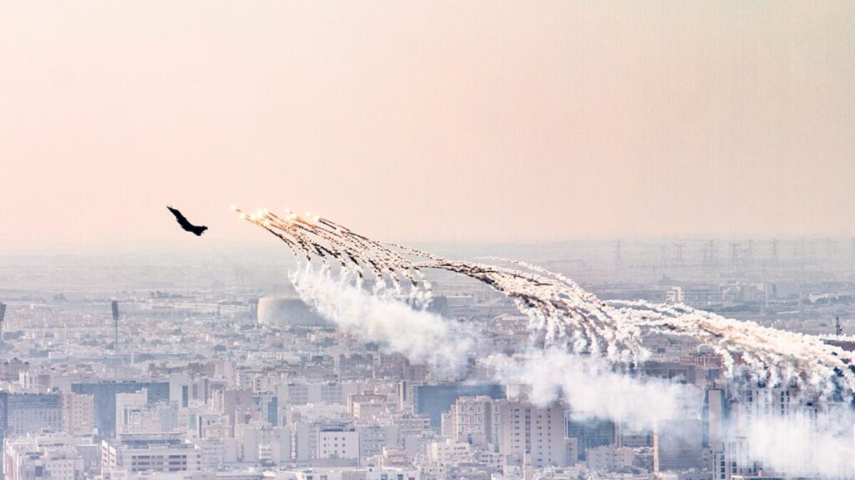 a group of airplanes flying over a city