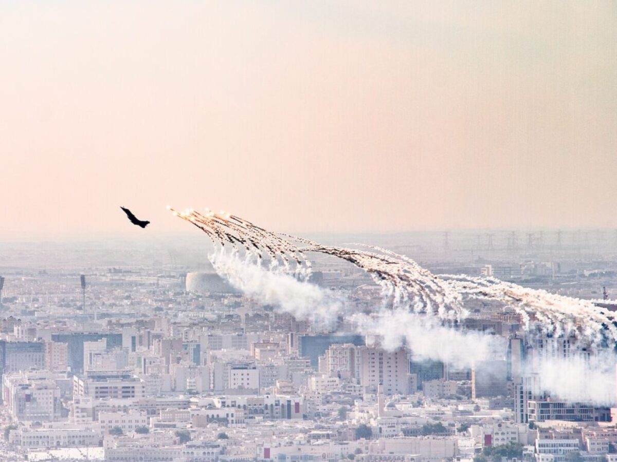 a group of airplanes flying over a city
