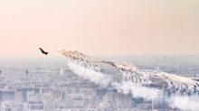 a group of airplanes flying over a city