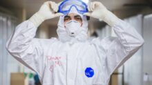 person in white and blue mask and white long sleeve shirt