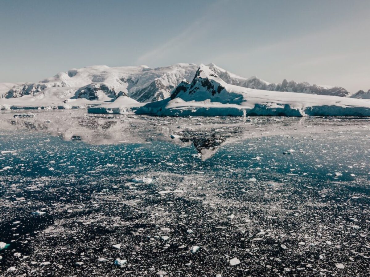 a large body of water surrounded by snow covered mountains