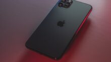 black iphone 7 plus on red table