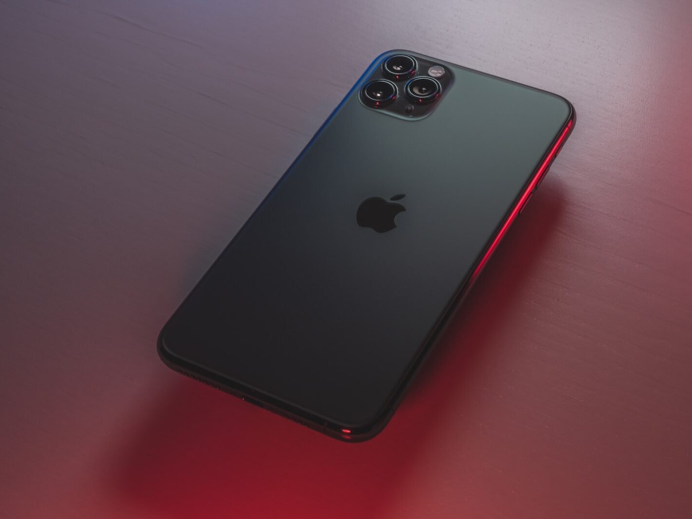 black iphone 7 plus on red table