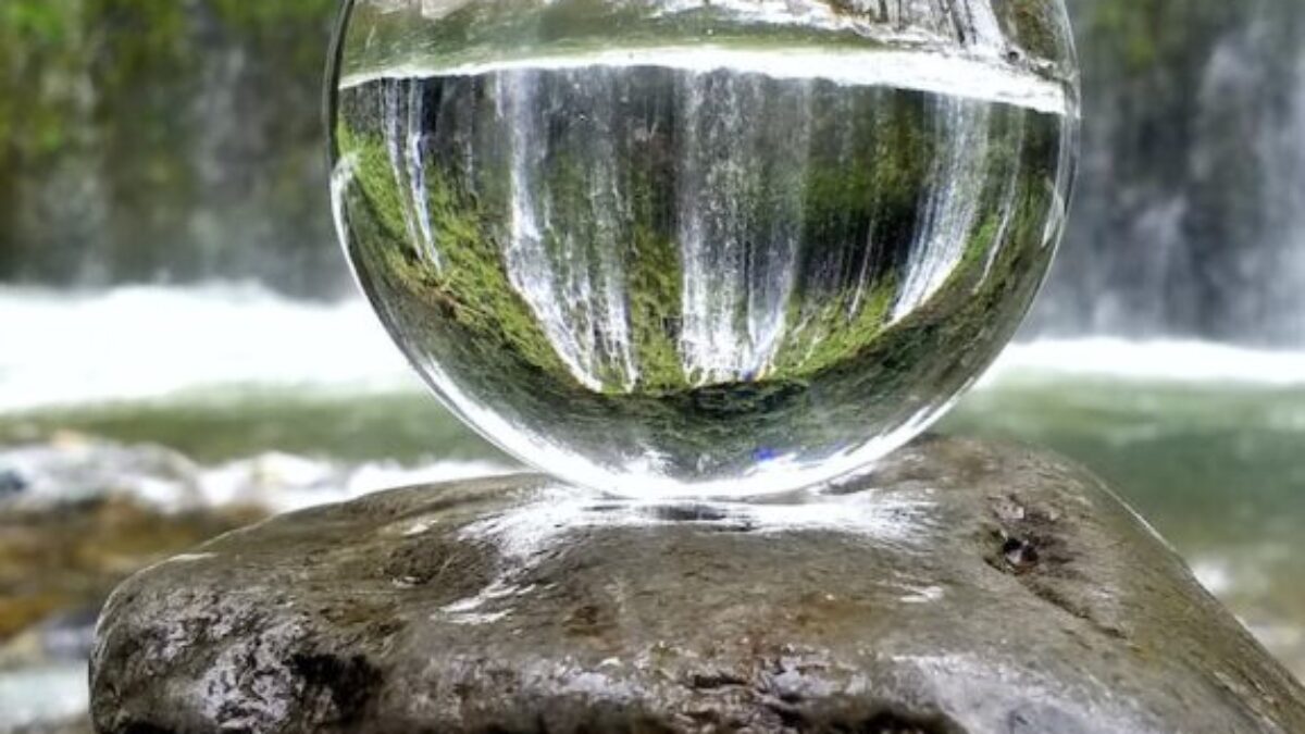 clear glass ball on brown rock