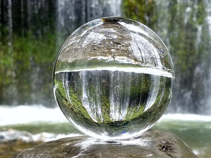 clear glass ball on brown rock