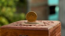 Gold Round Coin on Brown Wooden Piggy Bank
