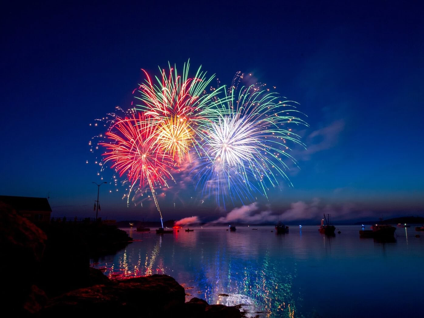 green, red, and white fireworks on sky at nighttime