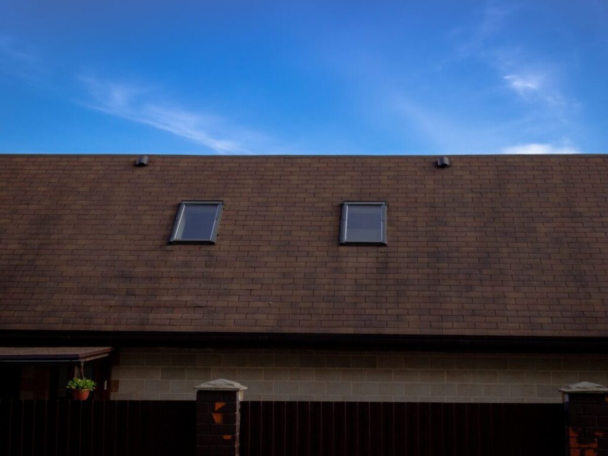 a house with two windows and a brown roof