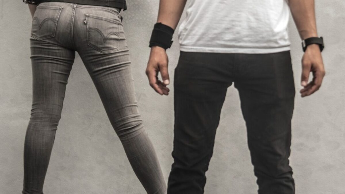 man in black pants beside woman in gray skinny jeans