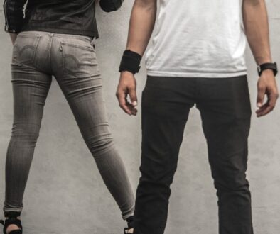 man in black pants beside woman in gray skinny jeans