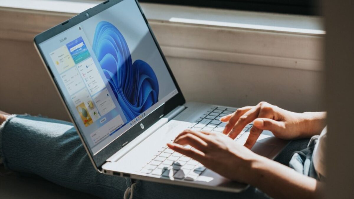person using Windows 11 computer on lap
