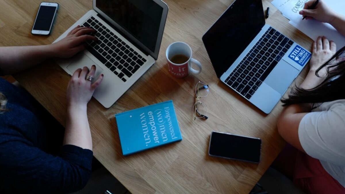 two person using laptops