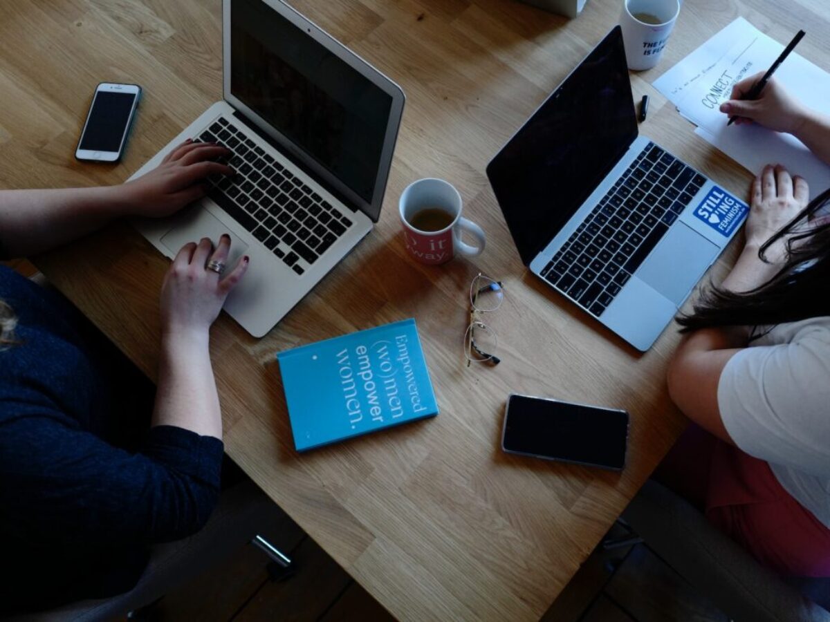 two person using laptops