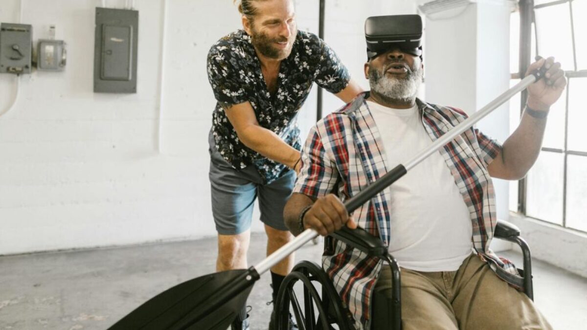 Man Helping a Man Play with Virtual Reality Headset