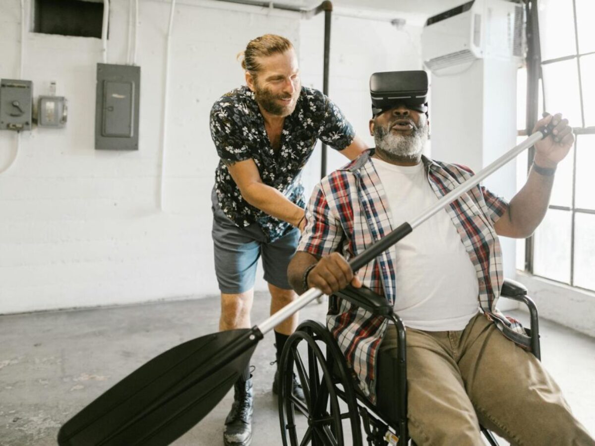 Man Helping a Man Play with Virtual Reality Headset