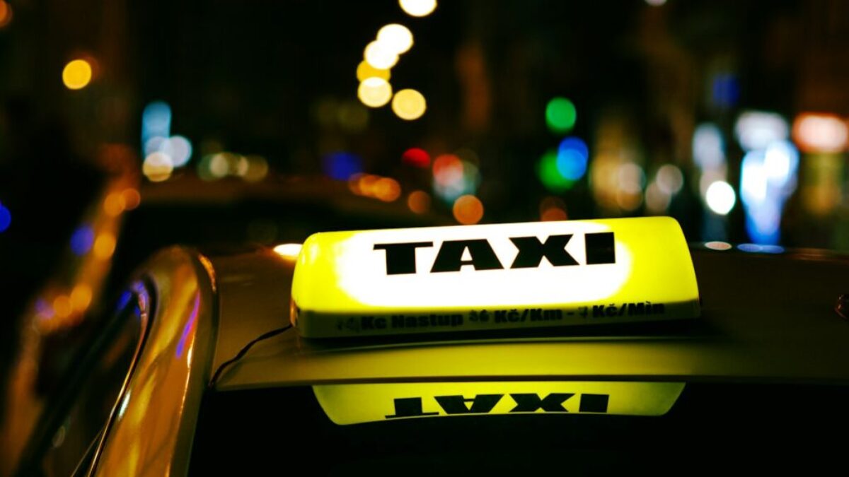 a taxi cab with a taxi light on top of it