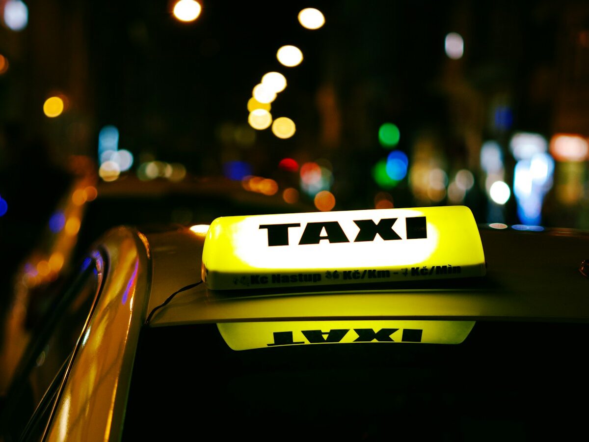 a taxi cab with a taxi light on top of it