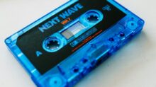 a blue tape recorder sitting on top of a table