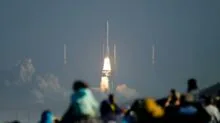 a crowd of people watching a rocket launch