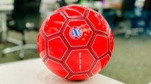 red soccer ball on white table