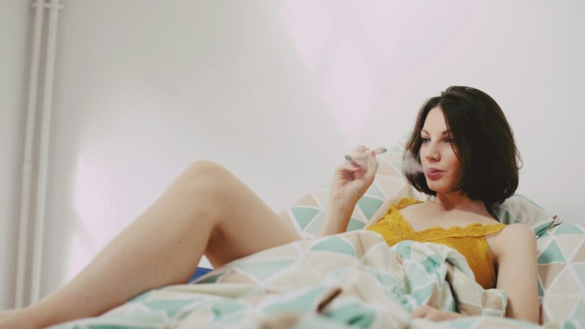 woman in yellow shirt lying on bed