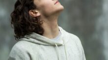 man in gray pullover hoodie closed eyes while heads up