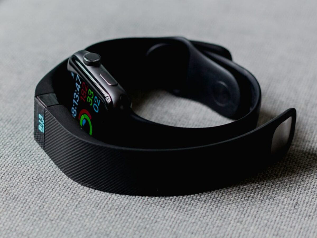 black aluminum case Apple Watch and black Fitbit charge 2