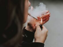 woman lights her cigarette with lighter