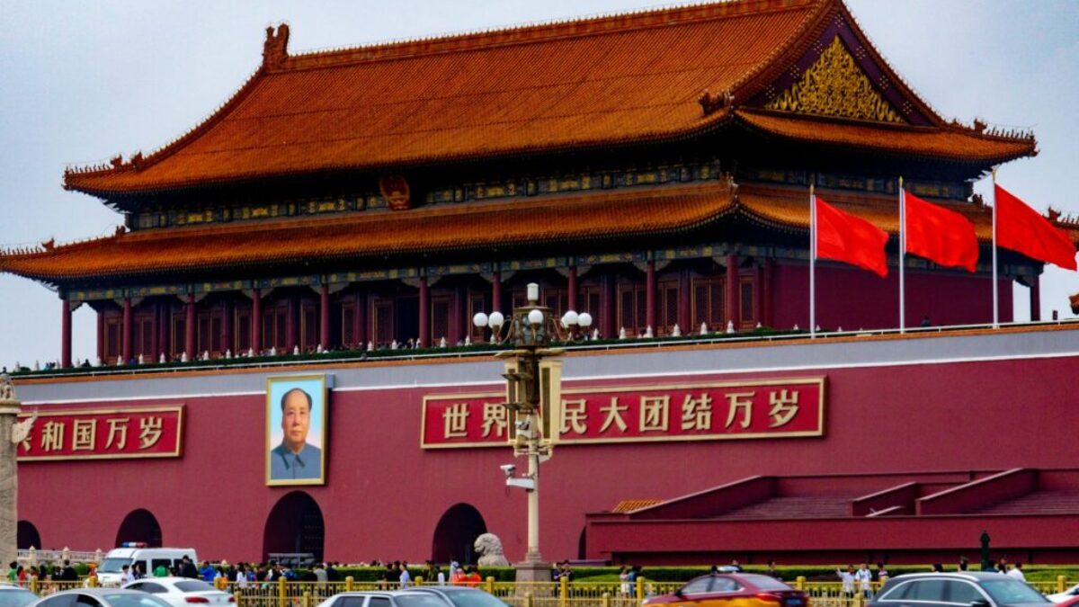 cars parked in front of red and brown building