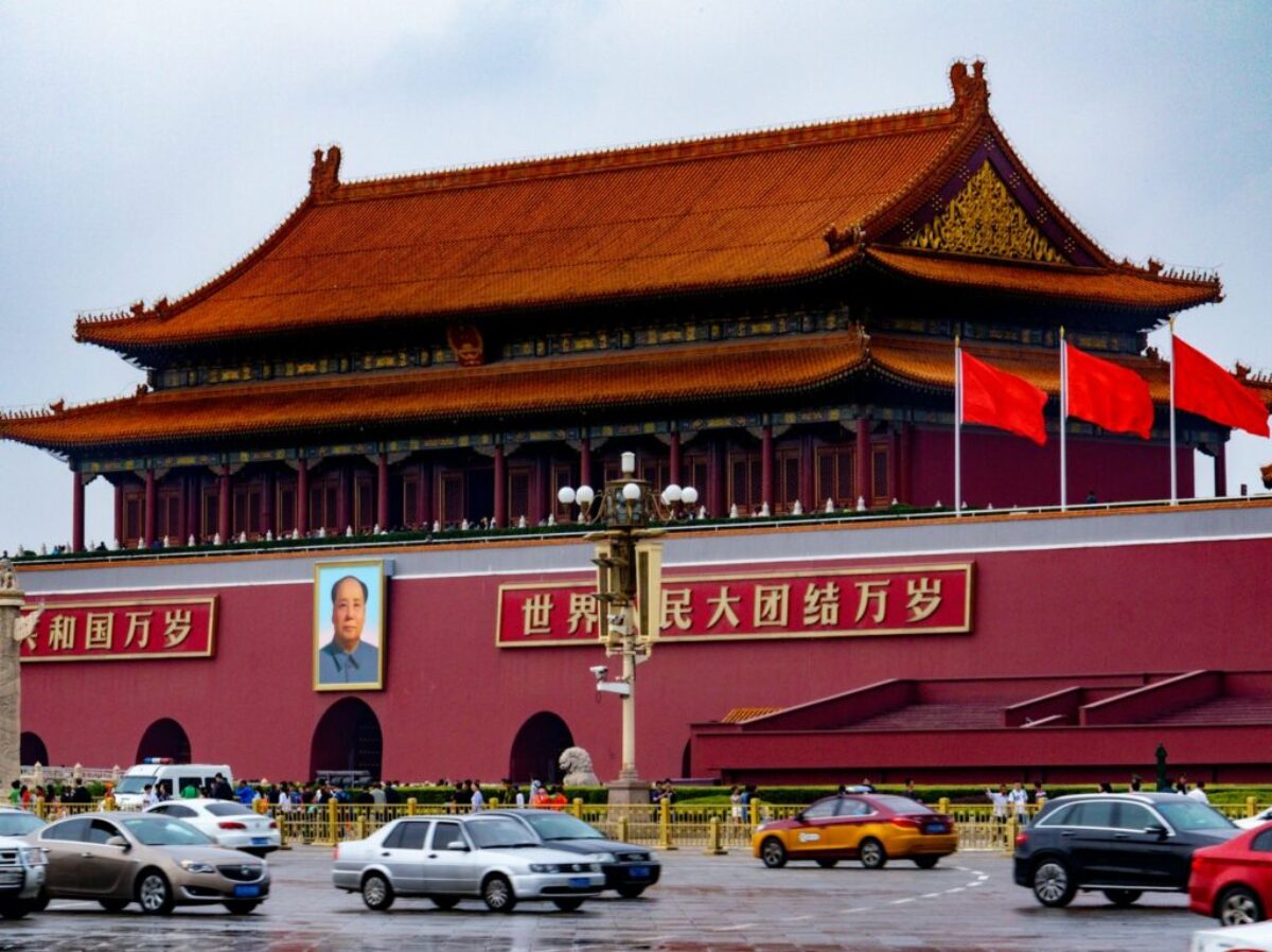 cars parked in front of red and brown building