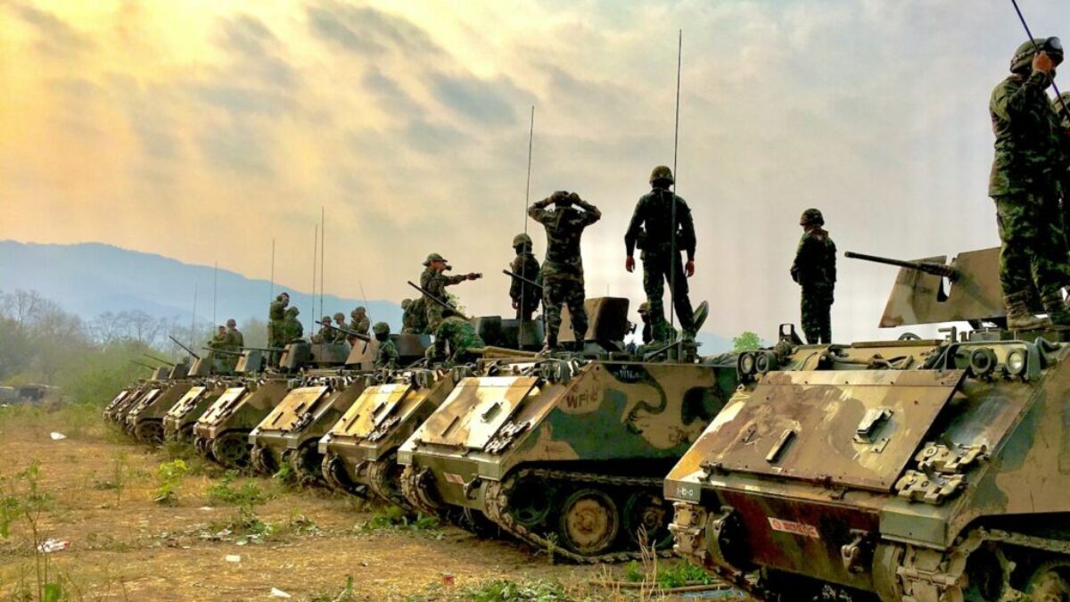soldiers on top of battle tanks