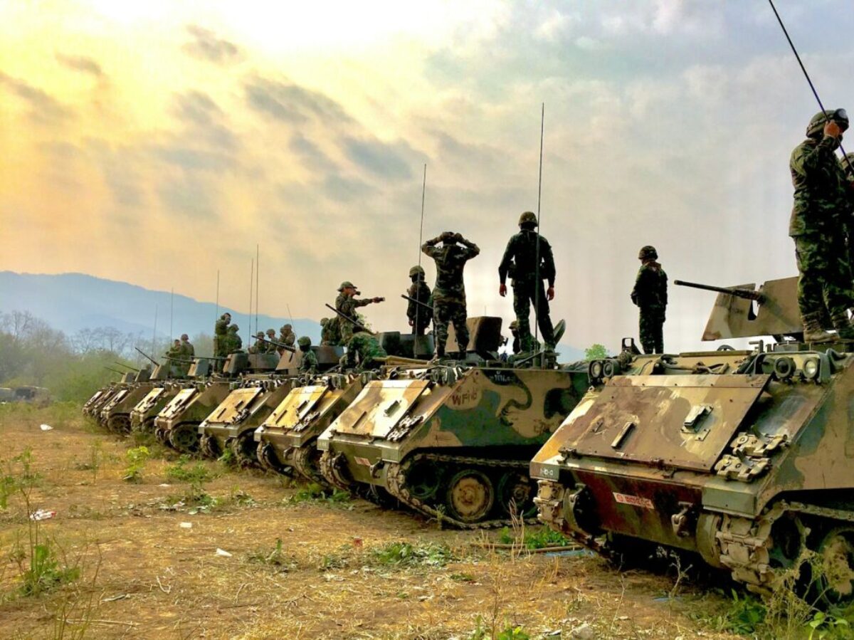 soldiers on top of battle tanks